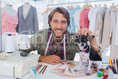 Fashion designer petting his chihuahua