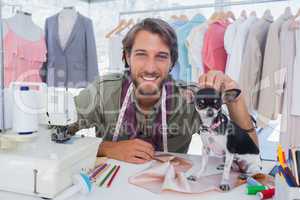 Fashion designer petting his chihuahua