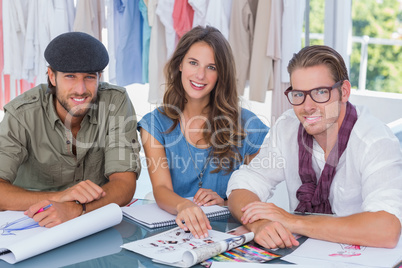 Team of fashion designers smiling to the camera
