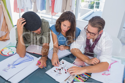 Three fashion designers working together