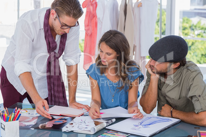 Fashion designer pointing a photo