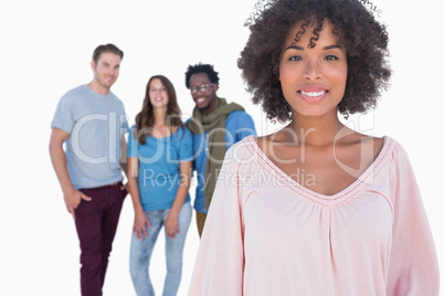 Fashionable woman smiling in front of stylish people