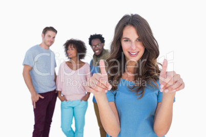 Woman with thumbs standing in front of stylish people