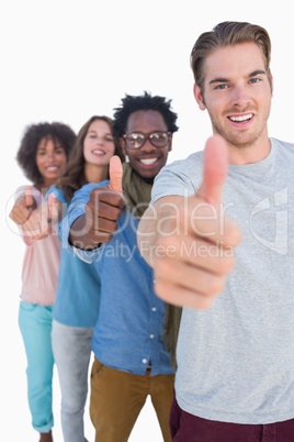 Cheerful people in row with thumbs up