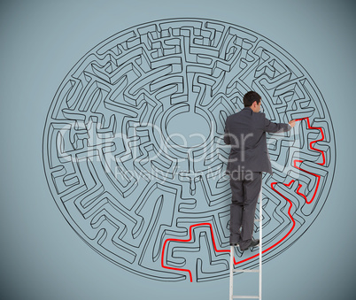 Businessman drawing red line to solve a maze