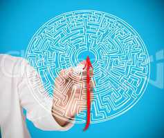 Businessman drawing red line to centre of maze