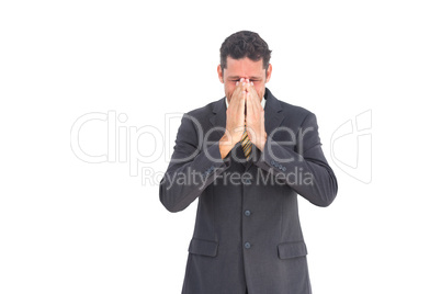 Troubled businessman with hands on his face