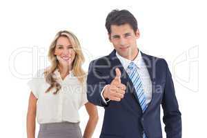 Businessman with thumb up and his smiling coworker
