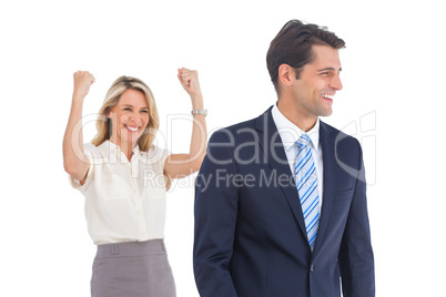 Businesswoman with raised arms and her coworker