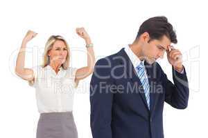 Anxious businessman and cheering businesswoman