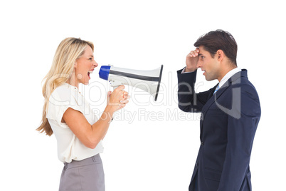 Businesswoman shouting at a businessman with megaphone