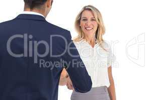 Businesswoman shaking hands and looking at the camera