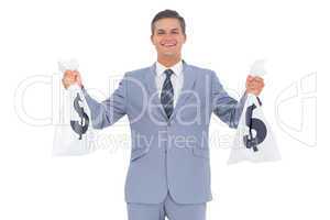 Businessman with cash bag in each hands