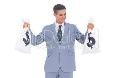 Businessman looking at cash bag