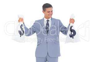 Businessman looking at cash bag