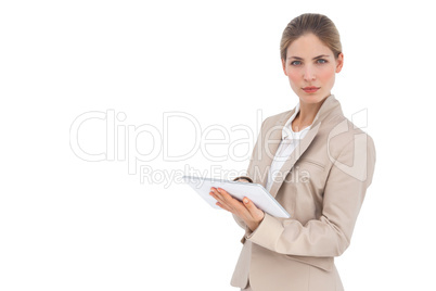 Serious businesswoman holding digital tablet