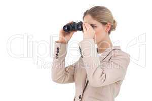 Businesswoman looking away with binoculars