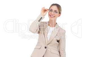 Smiling businesswoman holding her glasses