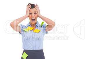 Businesswoman shouting with adhesive notes on her shirt