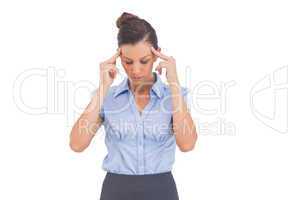 Businesswoman thinking with fingers on her temples