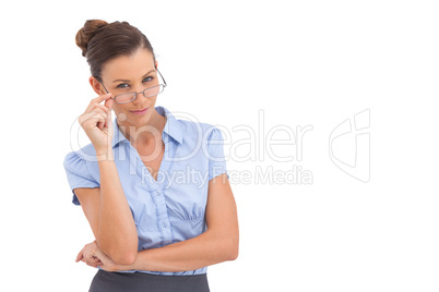 Smiling businesswoman adjusting her glasses