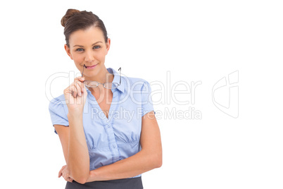 Smiling businesswoman with glasses on her mouth