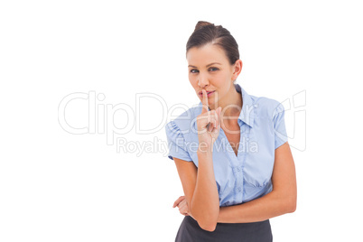 Businesswoman with finger on lips