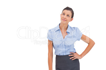 Businesswoman thinking with hand on hip