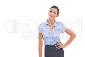 Businesswoman thinking with hand on hip