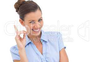 Smiling businesswoman pointing upwards