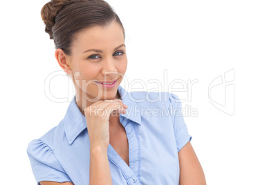 Smiling businesswoman with hand on chin