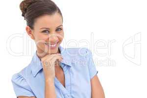 Cheerful businesswoman with hand on chin