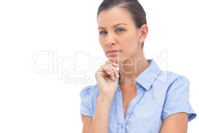 Stern businesswoman with hand on chin