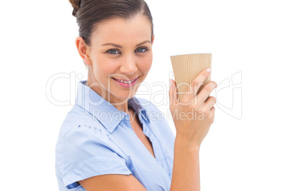 Businesswoman carrying coffee cup