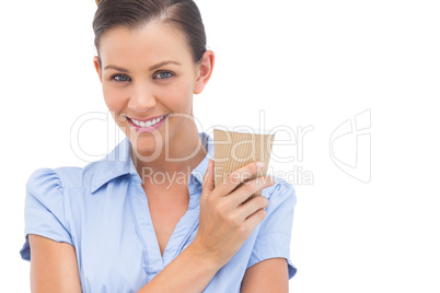 Smiling businesswoman with arms crossed and coffee cup