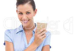 Smiling businesswoman with arms crossed and coffee cup