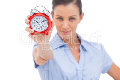 Businesswoman holding alarm clock