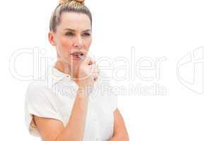 Focused businesswoman with pen on mouth