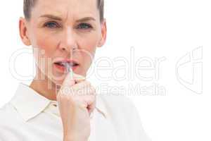 Worried businesswoman with pen on mouth