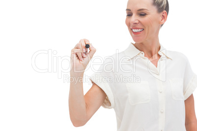 Smiling businesswoman looking at pen in her hand