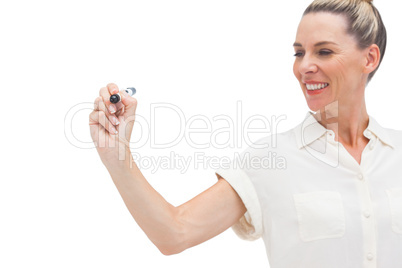 Smiling businesswoman looking at marker in her hand