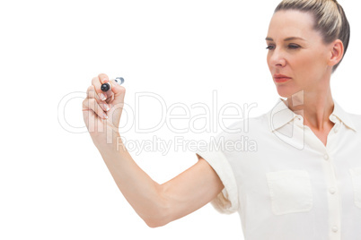 Serious businesswoman looking at pen in her hand