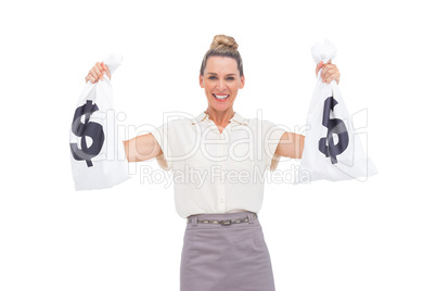 Smiling businesswoman holding money bags