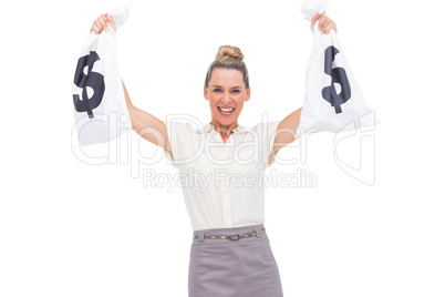 Smiling businesswoman showing money bags