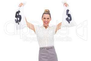 Smiling businesswoman showing money bags