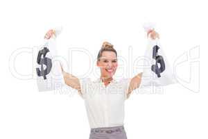 Smiling businesswoman carrying money bags