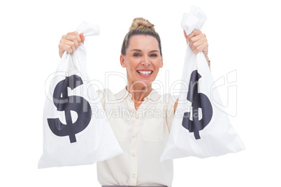 Smiling businesswoman carrying cash bags