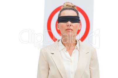 Businesswoman blindfolded and target behind