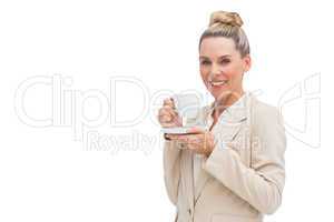 Smiling businesswoman holding a cup