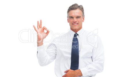 Mature businessman saying ok with hand